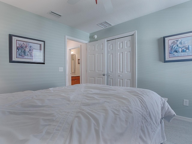 carpeted bedroom with ceiling fan and a closet