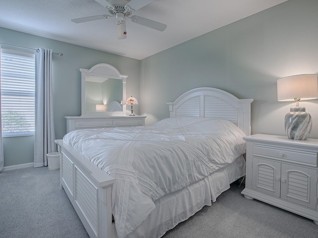 bedroom with ceiling fan and light colored carpet