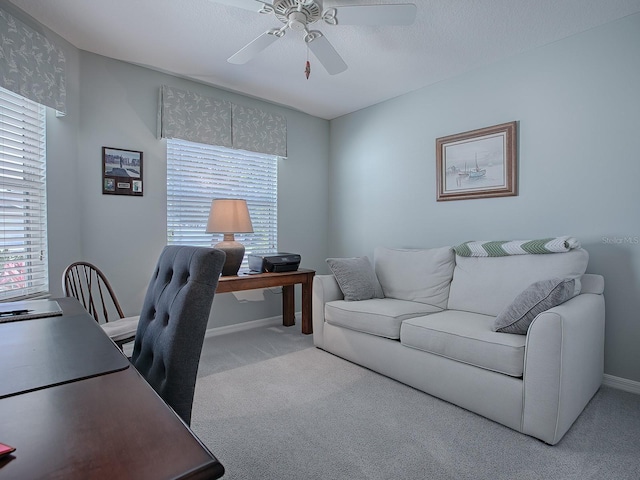 home office featuring light carpet, ceiling fan, and plenty of natural light