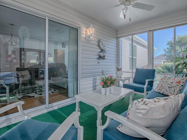 sunroom / solarium featuring ceiling fan