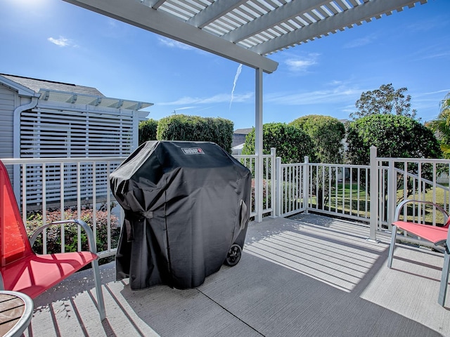 exterior space with a deck, a grill, and a pergola