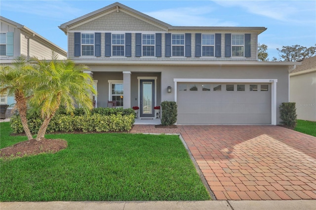 view of front of house featuring a front lawn and a garage