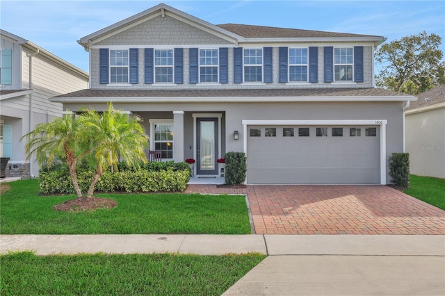 view of front of home with a garage and a front lawn