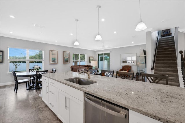 kitchen with light stone counters, stainless steel dishwasher, sink, white cabinetry, and hanging light fixtures