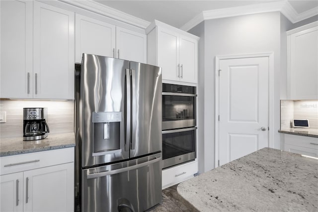 kitchen featuring white cabinets, backsplash, crown molding, and stainless steel appliances