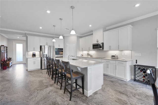 kitchen featuring sink, white cabinetry, a kitchen island with sink, and appliances with stainless steel finishes