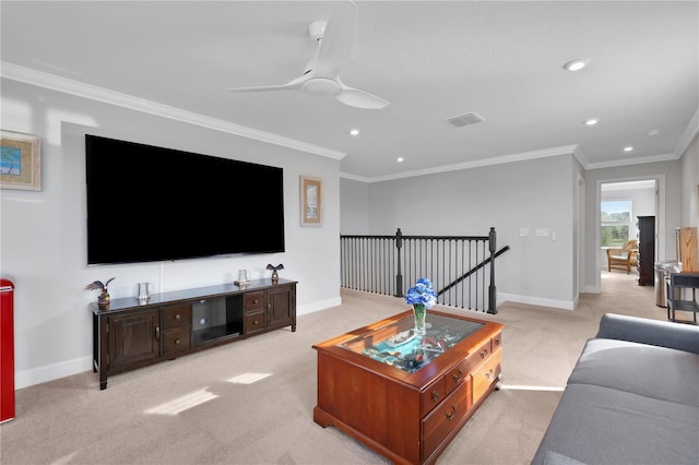 carpeted living room with ceiling fan and ornamental molding