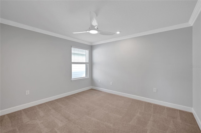 spare room featuring ceiling fan, crown molding, and light carpet