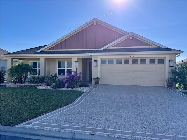 view of front of property with a front yard and a garage