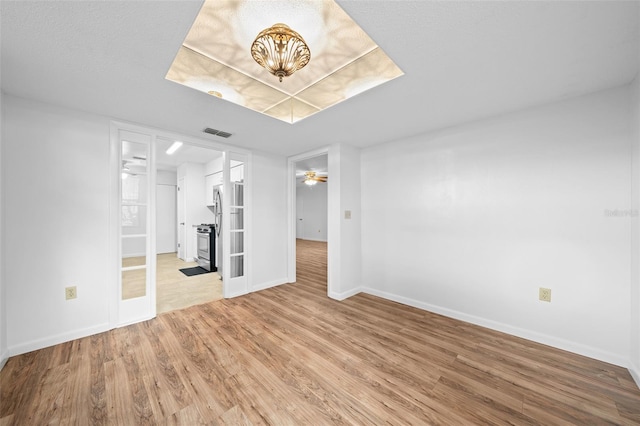 unfurnished living room featuring hardwood / wood-style flooring and ceiling fan