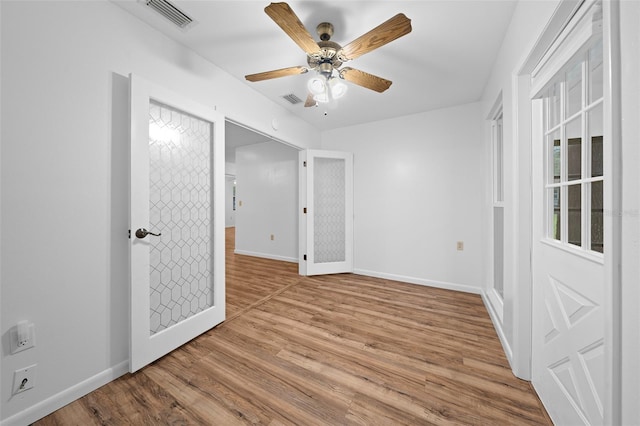 spare room featuring light wood-type flooring and ceiling fan