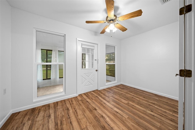 unfurnished room featuring hardwood / wood-style floors and ceiling fan