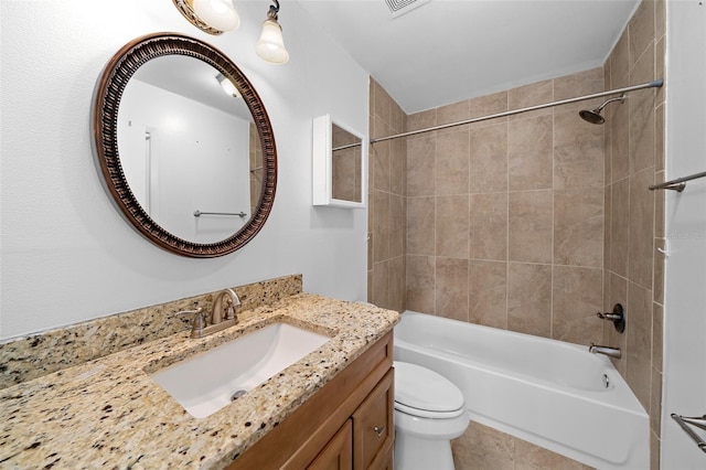 full bathroom with vanity, toilet, and tiled shower / bath