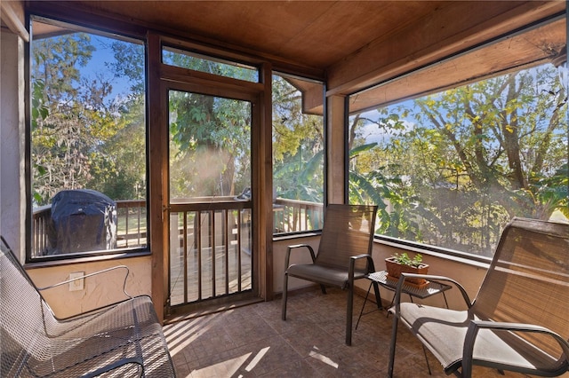 sunroom featuring wood ceiling