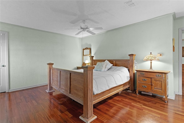 bedroom featuring ceiling fan, dark hardwood / wood-style flooring, and crown molding