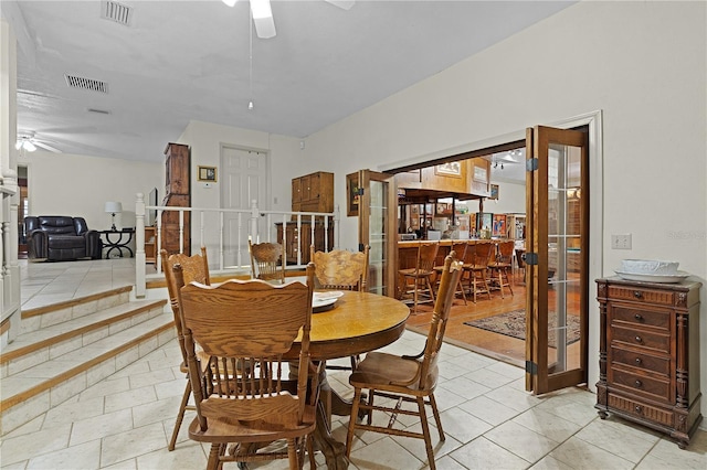 tiled dining room featuring french doors