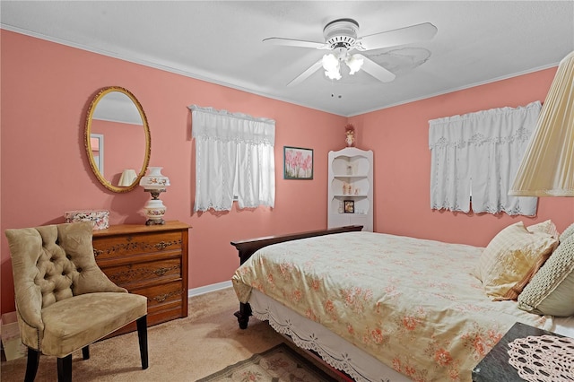 carpeted bedroom with ceiling fan and ornamental molding