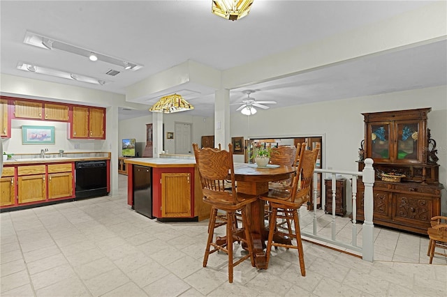 dining room with ceiling fan and sink