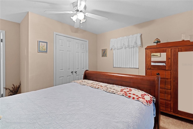 carpeted bedroom with ceiling fan and a closet