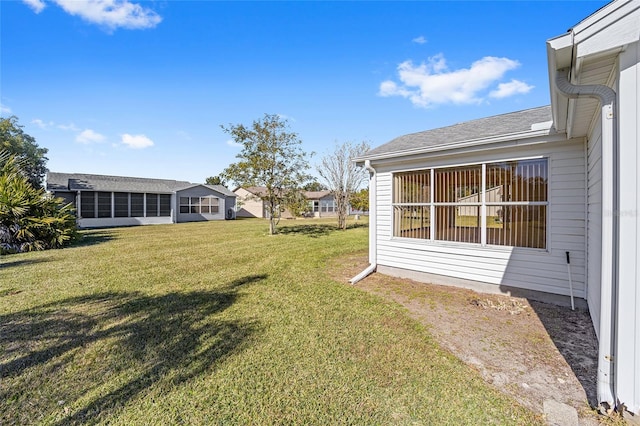 view of yard featuring a sunroom