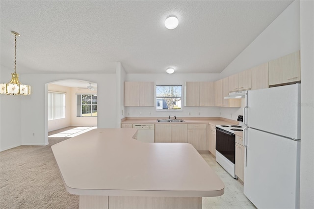 kitchen with a center island, sink, white appliances, a textured ceiling, and light brown cabinetry