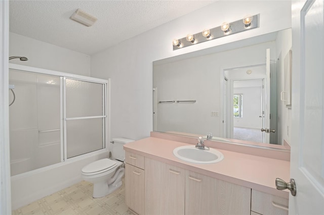 full bathroom featuring a textured ceiling, bath / shower combo with glass door, toilet, and vanity