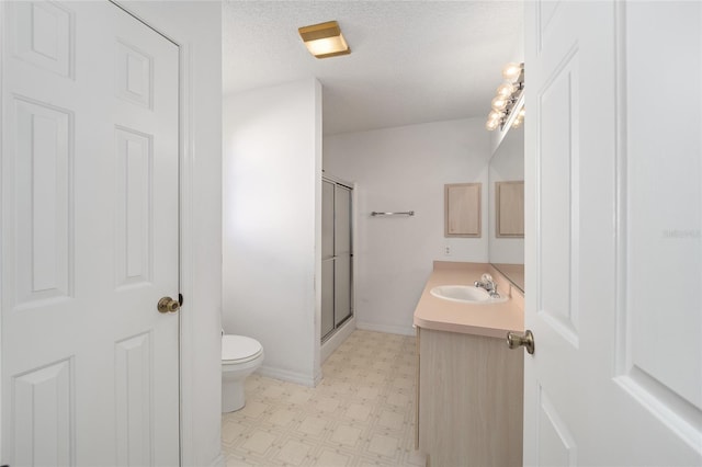 bathroom with walk in shower, vanity, toilet, and a textured ceiling