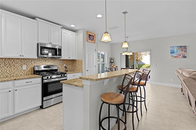 1741 Bonser Rd, Minneola, FL 34715 - kitchen with stainless steel appliances, tasteful backsplash, light tile patterned flooring, light stone counters, and white cabinetry