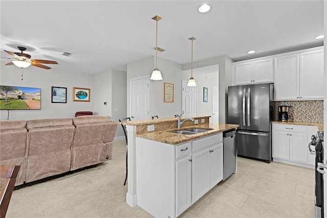 1741 Bonser Rd, Minneola, FL 34715 - kitchen with appliances with stainless steel finishes, open floor plan, light stone countertops, decorative backsplash, and recessed lighting