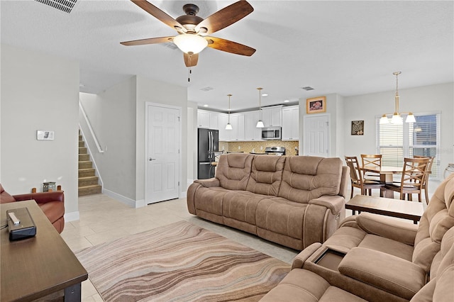 1741 Bonser Rd, Minneola, FL 34715 - living area with ceiling fan, stairway, and light tile patterned floors