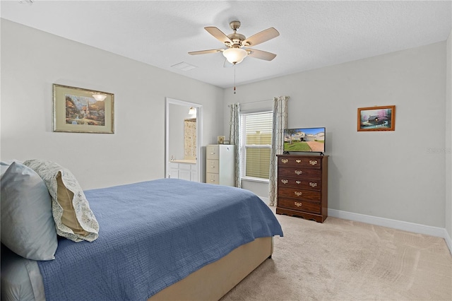 carpeted bedroom featuring ensuite bath and ceiling fan