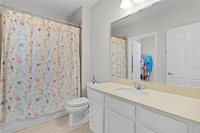 bathroom with a textured ceiling, vanity, toilet, and curtained shower