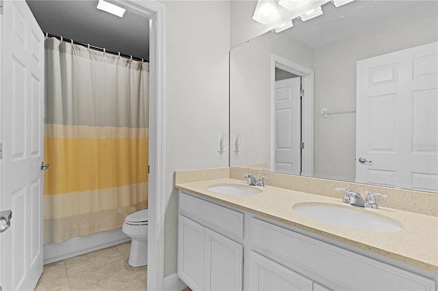 full bathroom featuring tile patterned floors, shower / bath combo with shower curtain, vanity, and toilet