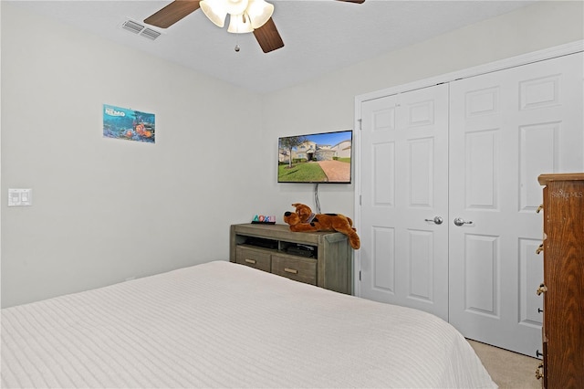 carpeted bedroom with a closet and ceiling fan