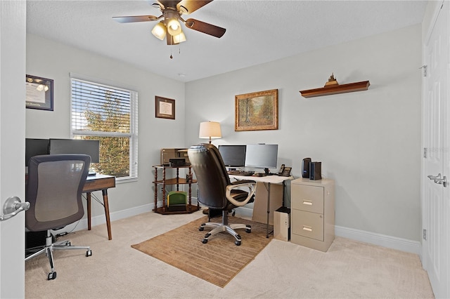 office area with ceiling fan and light carpet