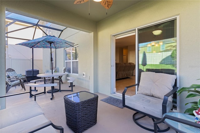 view of patio / terrace featuring ceiling fan and a lanai