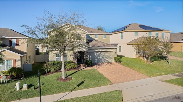 view of front of property featuring a garage and a front lawn