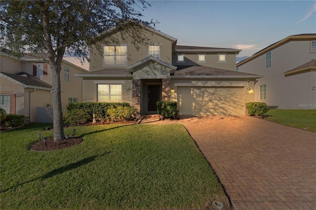 view of front of property featuring a yard and a garage