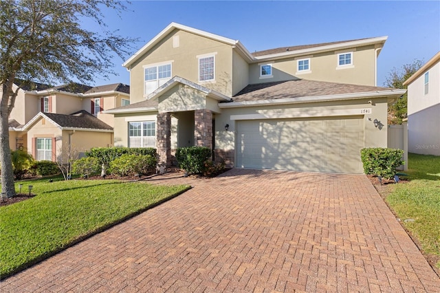 front of property with a garage and a front lawn