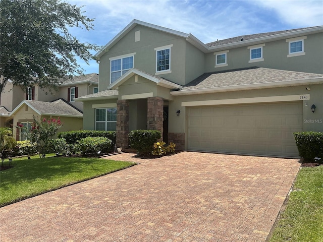 1741 Bonser Rd, Minneola, FL 34715 - view of front of property featuring stucco siding, decorative driveway, stone siding, and a front yard