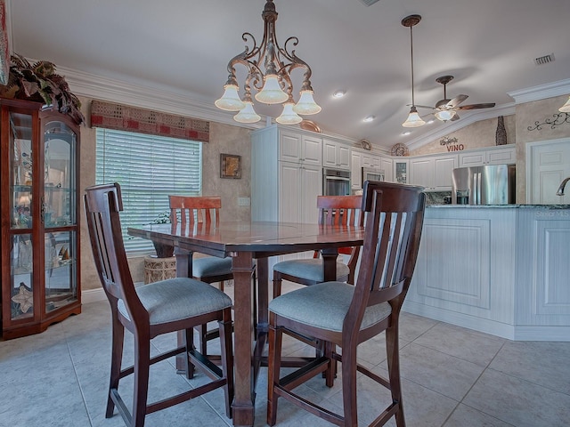 dining area with lofted ceiling, crown molding, light tile patterned flooring, and ceiling fan with notable chandelier