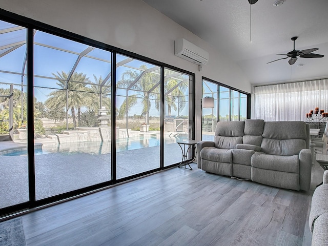 unfurnished living room featuring light hardwood / wood-style flooring, an AC wall unit, ceiling fan, and lofted ceiling