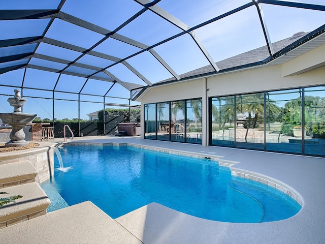 view of swimming pool with pool water feature, a patio, a hot tub, and a lanai