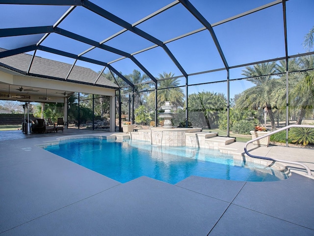 view of swimming pool with pool water feature, a patio area, ceiling fan, and a lanai