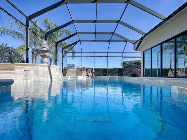 view of pool with a lanai and pool water feature