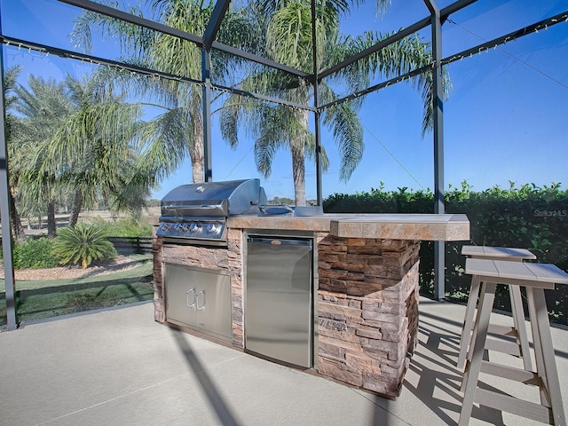 view of patio featuring area for grilling and exterior kitchen