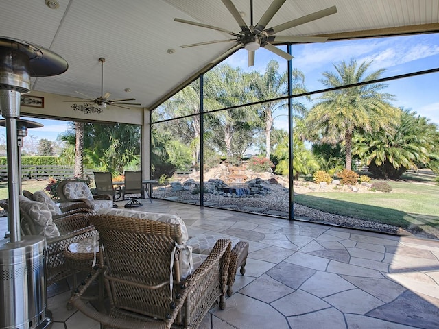 unfurnished sunroom featuring ceiling fan