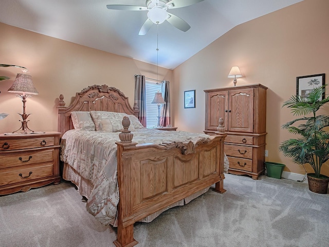 carpeted bedroom with ceiling fan and vaulted ceiling