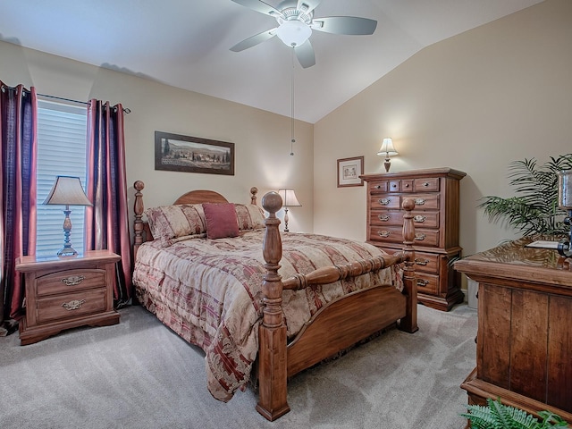 bedroom with ceiling fan, light colored carpet, and vaulted ceiling