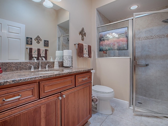 bathroom featuring tile patterned flooring, vanity, and walk in shower